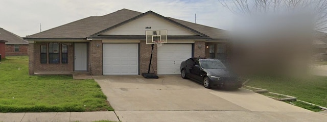 2808 Lucille Dr Unit A & B, Killeen, TX 76549 - view of front of home with brick siding, a garage, driveway, and a front yard