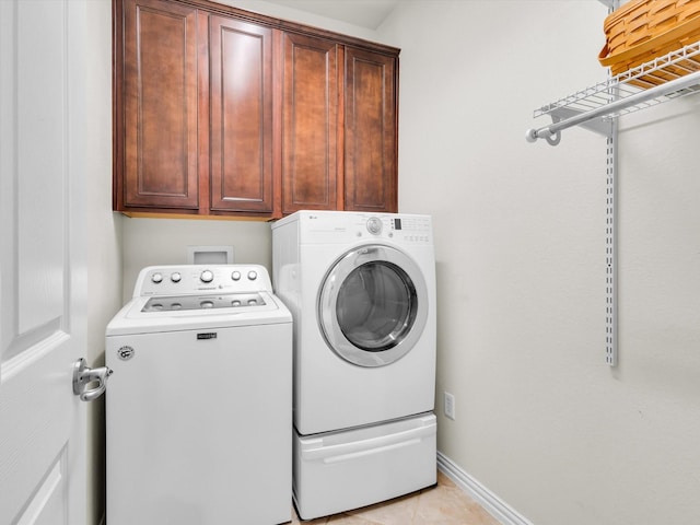 4344 Kestrel Way, Carrollton, TX 75010 - washroom with washing machine and clothes dryer, cabinet space, and light tile patterned floors