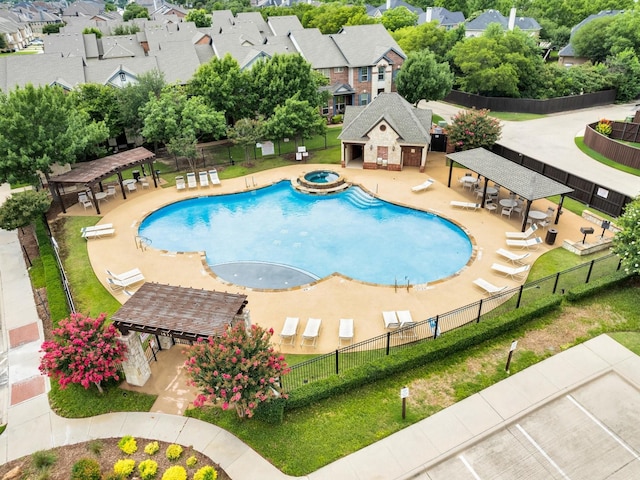 4344 Kestrel Way, Carrollton, TX 75010 - view of swimming pool with a gazebo, an outbuilding, a pool with connected hot tub, a storage structure, and a residential view