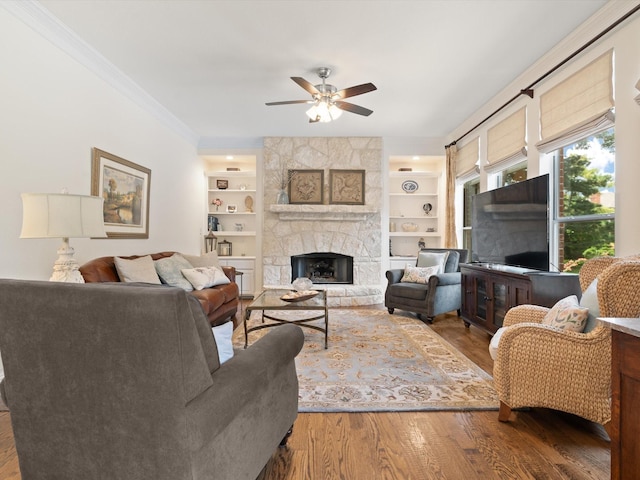 6301 Bermuda Dunes Dr, Plano, TX 75093 - living area featuring a ceiling fan, crown molding, wood finished floors, built in shelves, and a fireplace