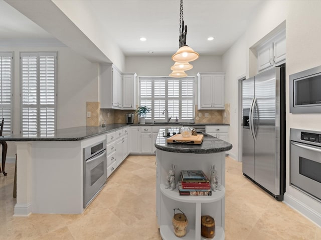 6301 Bermuda Dunes Dr, Plano, TX 75093 - kitchen featuring appliances with stainless steel finishes, open shelves, a peninsula, decorative backsplash, and white cabinetry