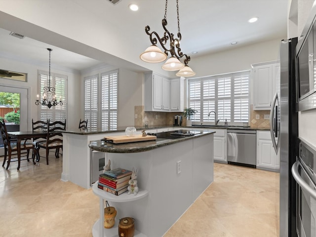 6301 Bermuda Dunes Dr, Plano, TX 75093 - kitchen featuring appliances with stainless steel finishes, open shelves, a chandelier, plenty of natural light, and recessed lighting