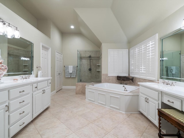 6301 Bermuda Dunes Dr, Plano, TX 75093 - bathroom featuring a bath, two vanities, vaulted ceiling, a tile shower, and tile patterned flooring