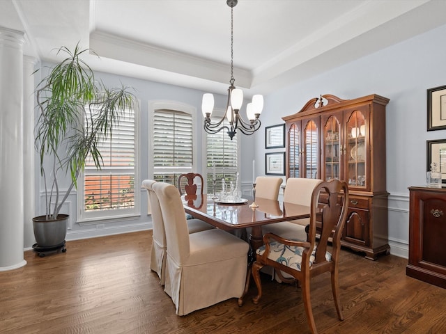 6301 Bermuda Dunes Dr, Plano, TX 75093 - dining space featuring crown molding, a chandelier, a raised ceiling, dark wood-style floors, and decorative columns