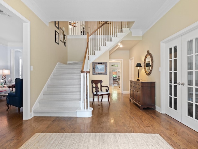 6301 Bermuda Dunes Dr, Plano, TX 75093 - staircase with french doors, crown molding, wood finished floors, and a chandelier