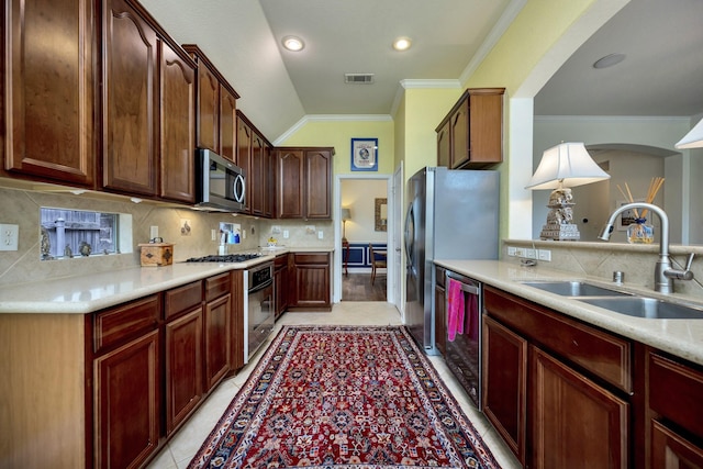 9708 Sinclair St, Fort Worth, TX 76244 - kitchen featuring appliances with stainless steel finishes, crown molding, decorative backsplash, light countertops, and vaulted ceiling