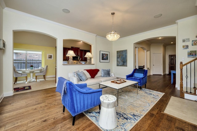 9708 Sinclair St, Fort Worth, TX 76244 - living room featuring arched walkways, stairway, ornamental molding, wood finished floors, and a chandelier