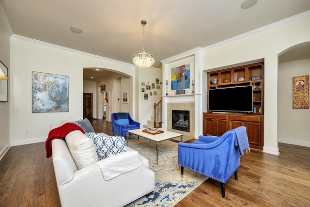 9708 Sinclair St, Fort Worth, TX 76244 - living area featuring arched walkways, ornamental molding, wood finished floors, a fireplace, and a chandelier