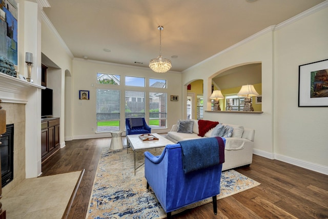 9708 Sinclair St, Fort Worth, TX 76244 - living room with crown molding, a tiled fireplace, arched walkways, dark wood finished floors, and plenty of natural light