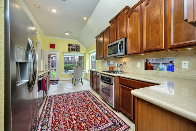 9708 Sinclair St, Fort Worth, TX 76244 - kitchen with appliances with stainless steel finishes, tasteful backsplash, ornamental molding, vaulted ceiling, and light tile patterned flooring