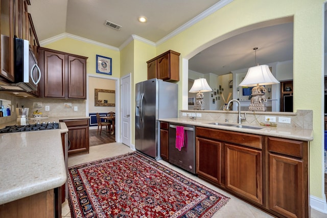 9708 Sinclair St, Fort Worth, TX 76244 - kitchen with appliances with stainless steel finishes, arched walkways, light countertops, backsplash, and ornamental molding