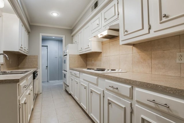 10630 Sandpiper Ln, Dallas, TX 75230 - kitchen with a sink, under cabinet range hood, ornamental molding, white appliances, and light tile patterned flooring