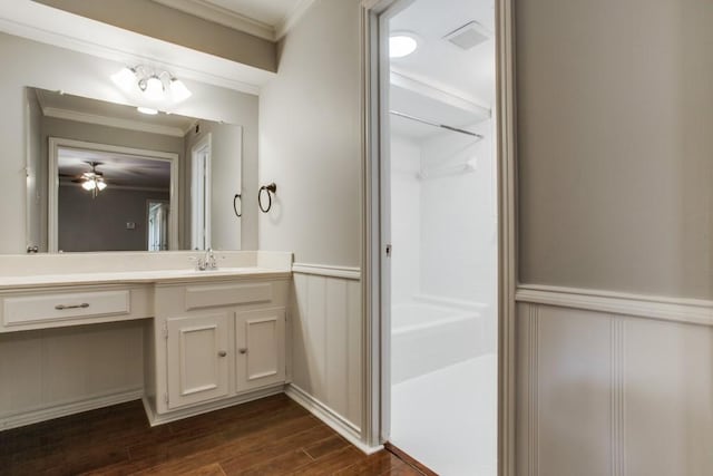 10630 Sandpiper Ln, Dallas, TX 75230 - bathroom with crown molding, wood finished floors, vanity, a shower, and a decorative wall