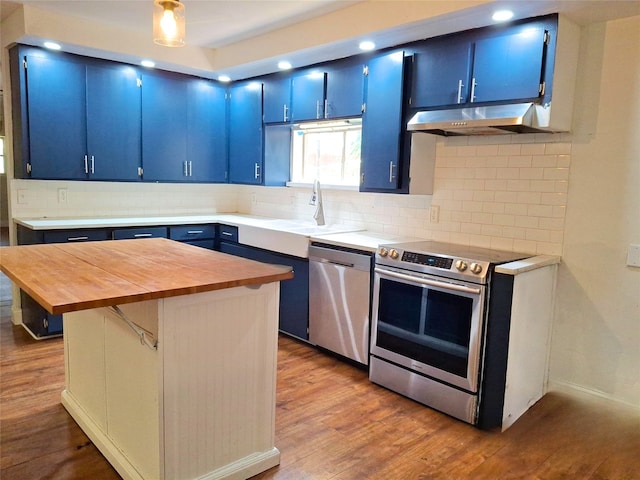 3717 W Spurgeon St, Fort Worth, TX 76133 - kitchen featuring blue cabinets, appliances with stainless steel finishes, under cabinet range hood, butcher block countertops, and a sink