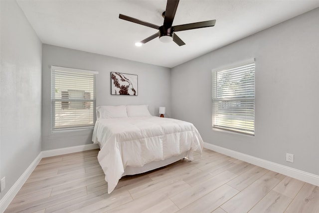228 Harrison Ln, Hurst, TX 76053 - bedroom with baseboards, multiple windows, and light wood-style floors