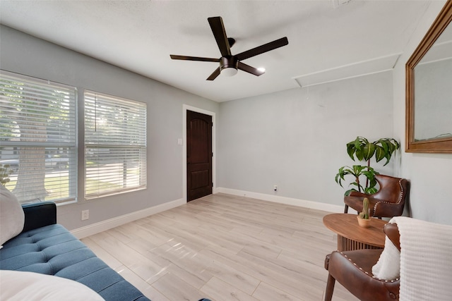 228 Harrison Ln, Hurst, TX 76053 - living area featuring attic access, a ceiling fan, baseboards, and light wood finished floors