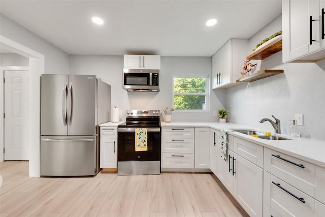 228 Harrison Ln, Hurst, TX 76053 - kitchen with appliances with stainless steel finishes, a sink, open shelves, white cabinets, and light countertops