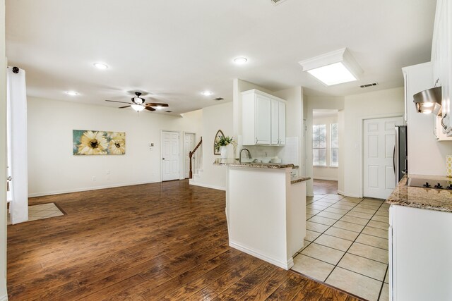 2001 Bosbury Dr, Flower Mound, TX 75028 - kitchen featuring exhaust hood, a sink, appliances with stainless steel finishes, white cabinetry, and tasteful backsplash