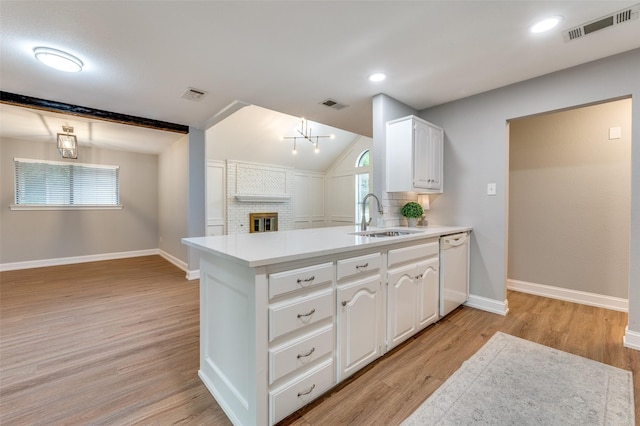7581 Kings Ridge Rd, Frisco, TX 75035 - kitchen featuring a sink, white dishwasher, white cabinetry, open floor plan, and a peninsula