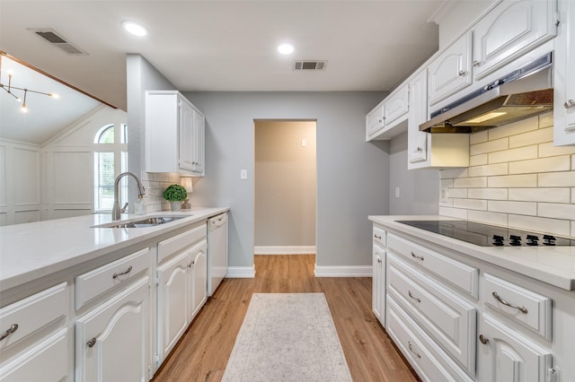 7581 Kings Ridge Rd, Frisco, TX 75035 - kitchen with under cabinet range hood, a sink, dishwasher, black electric cooktop, and white cabinetry