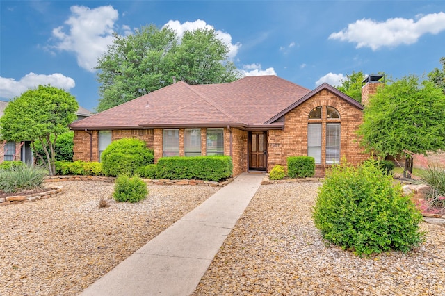 7581 Kings Ridge Rd, Frisco, TX 75035 - view of front of home with brick siding, roof with shingles, and a chimney