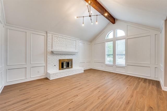 7581 Kings Ridge Rd, Frisco, TX 75035 - unfurnished living room with a decorative wall, a chandelier, light wood-style flooring, and a brick fireplace