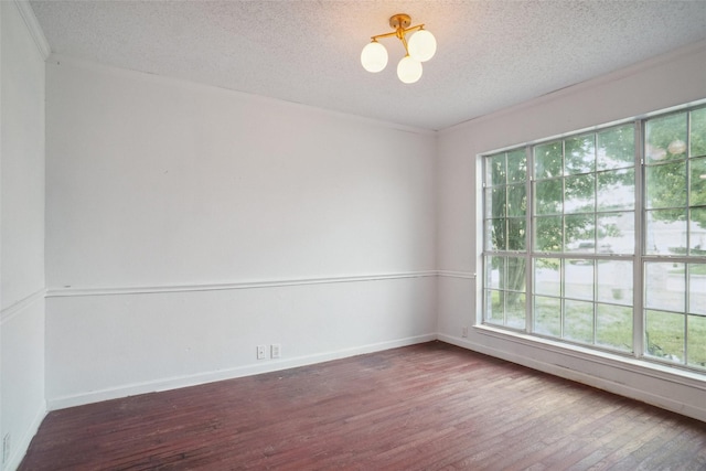 317 Stately Oak Ln, Lake Dallas, TX 75065 - spare room with wood finished floors, a textured ceiling, a chandelier, baseboards, and crown molding