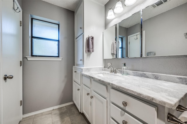 612 Meadow Ln, Roanoke, TX 76262 - bathroom with vanity, a textured ceiling, and tile patterned flooring