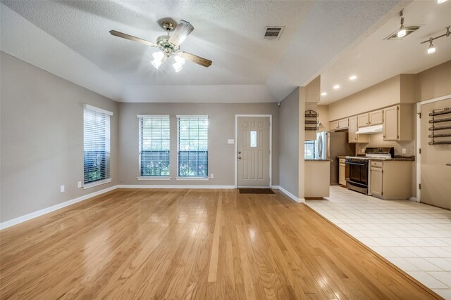 612 Meadow Ln, Roanoke, TX 76262 - unfurnished living room featuring a ceiling fan, light wood-type flooring, and a textured ceiling