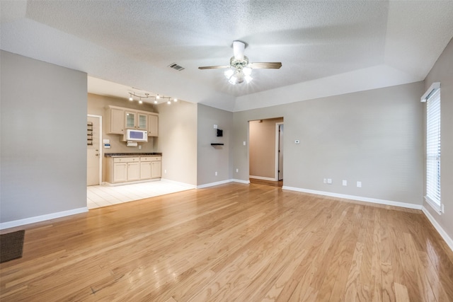 612 Meadow Ln, Roanoke, TX 76262 - unfurnished living room with ceiling fan, light wood-type flooring, and a textured ceiling