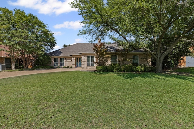 7009 Brookvale Rd, Fort Worth, TX 76132 - view of front of house with a front lawn, concrete driveway, and a chimney