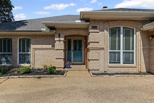 7009 Brookvale Rd, Fort Worth, TX 76132 - doorway to property with a shingled roof and brick siding