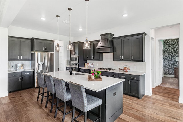 288 Ontario Loop, Sunnyvale, TX 75182 - kitchen featuring custom exhaust hood, stainless steel appliances, a sink, a kitchen breakfast bar, and decorative backsplash