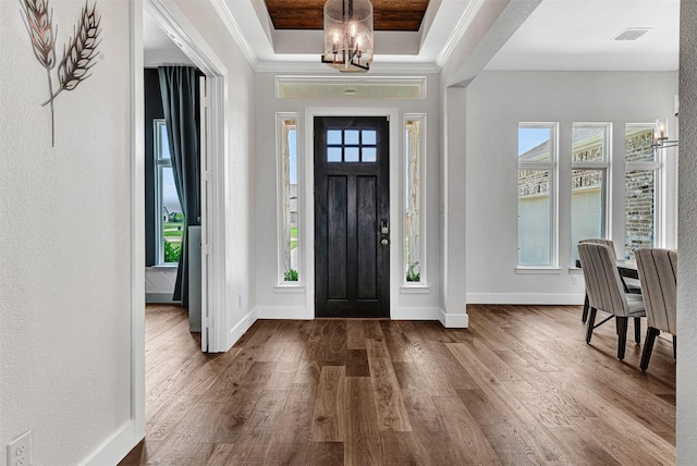 288 Ontario Loop, Sunnyvale, TX 75182 - entryway featuring a raised ceiling, dark wood-style floors, a chandelier, plenty of natural light, and ornamental molding