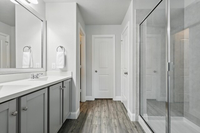 6105 Hightower St, Celina, TX 76227 - full bath with vanity, a shower stall, wood finished floors, and baseboards