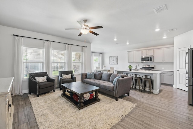 6105 Hightower St, Celina, TX 76227 - living area with ceiling fan, recessed lighting, light wood-style floors, and baseboards