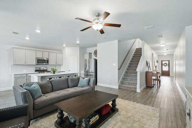 6105 Hightower St, Celina, TX 76227 - living area featuring a ceiling fan, stairs, light wood-type flooring, baseboards, and recessed lighting