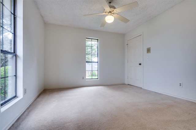 1541 Croston Dr, Plano, TX 75075 - unfurnished room with a textured ceiling, light colored carpet, ceiling fan, and baseboards
