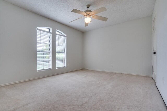 1541 Croston Dr, Plano, TX 75075 - unfurnished room featuring light carpet, a textured ceiling, a ceiling fan, and baseboards