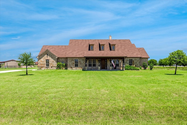 6708 Mustang Trl, Sanger, TX 76266 - cape cod-style house featuring a front lawn, a chimney, and stone siding