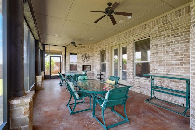 6708 Mustang Trl, Sanger, TX 76266 - sunroom / solarium with ceiling fan, outdoor dining area, an outdoor brick fireplace, and french doors