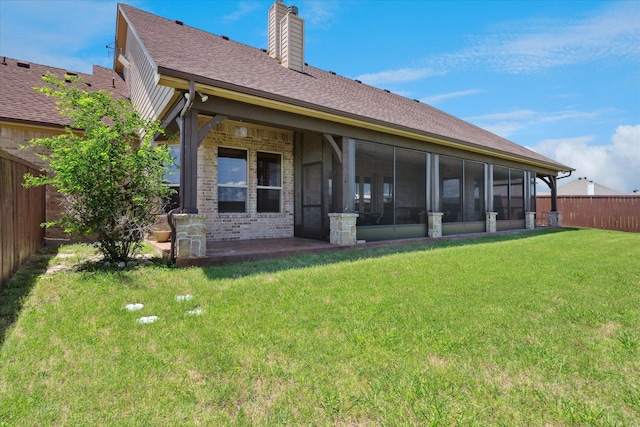 6708 Mustang Trl, Sanger, TX 76266 - back of property with a fenced backyard, a chimney, a sunroom, brick siding, and a shingled roof