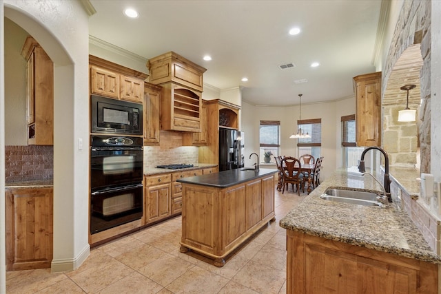 6708 Mustang Trl, Sanger, TX 76266 - kitchen with black appliances, decorative backsplash, a center island with sink, recessed lighting, and dark stone counters