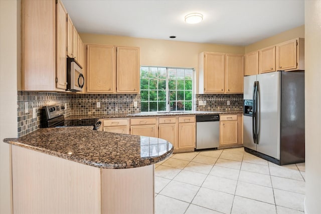 10120 Preston Vineyard Dr, Frisco, TX 75035 - kitchen with appliances with stainless steel finishes, light brown cabinets, a peninsula, decorative backsplash, and dark stone countertops