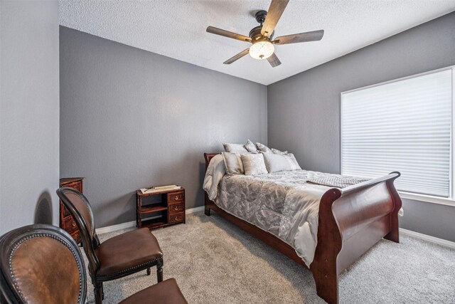 7340 Skillman St Unit 1207, Dallas, TX 75231 - carpeted bedroom featuring baseboards, ceiling fan, and a textured ceiling