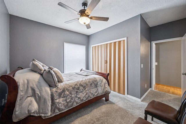 7340 Skillman St Unit 1207, Dallas, TX 75231 - bedroom featuring a textured wall, carpet floors, ceiling fan, and a textured ceiling