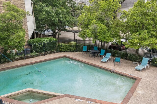 7340 Skillman St Unit 1207, Dallas, TX 75231 - view of swimming pool with an in-ground hot tub and a patio