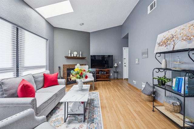 7340 Skillman St Unit 1207, Dallas, TX 75231 - living room with a skylight and wood finished floors