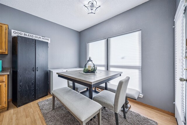 7340 Skillman St Unit 1207, Dallas, TX 75231 - dining space with light wood-style floors and a textured ceiling