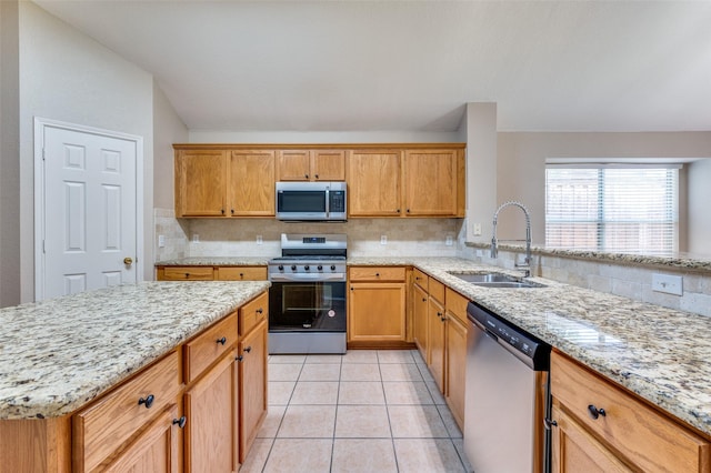 1117 Red Hawk Dr, Frisco, TX 75033 - kitchen featuring appliances with stainless steel finishes, a sink, light stone countertops, and decorative backsplash